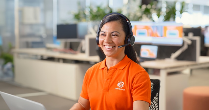 Smiling call centre agent answers the phone for Alinta Energy