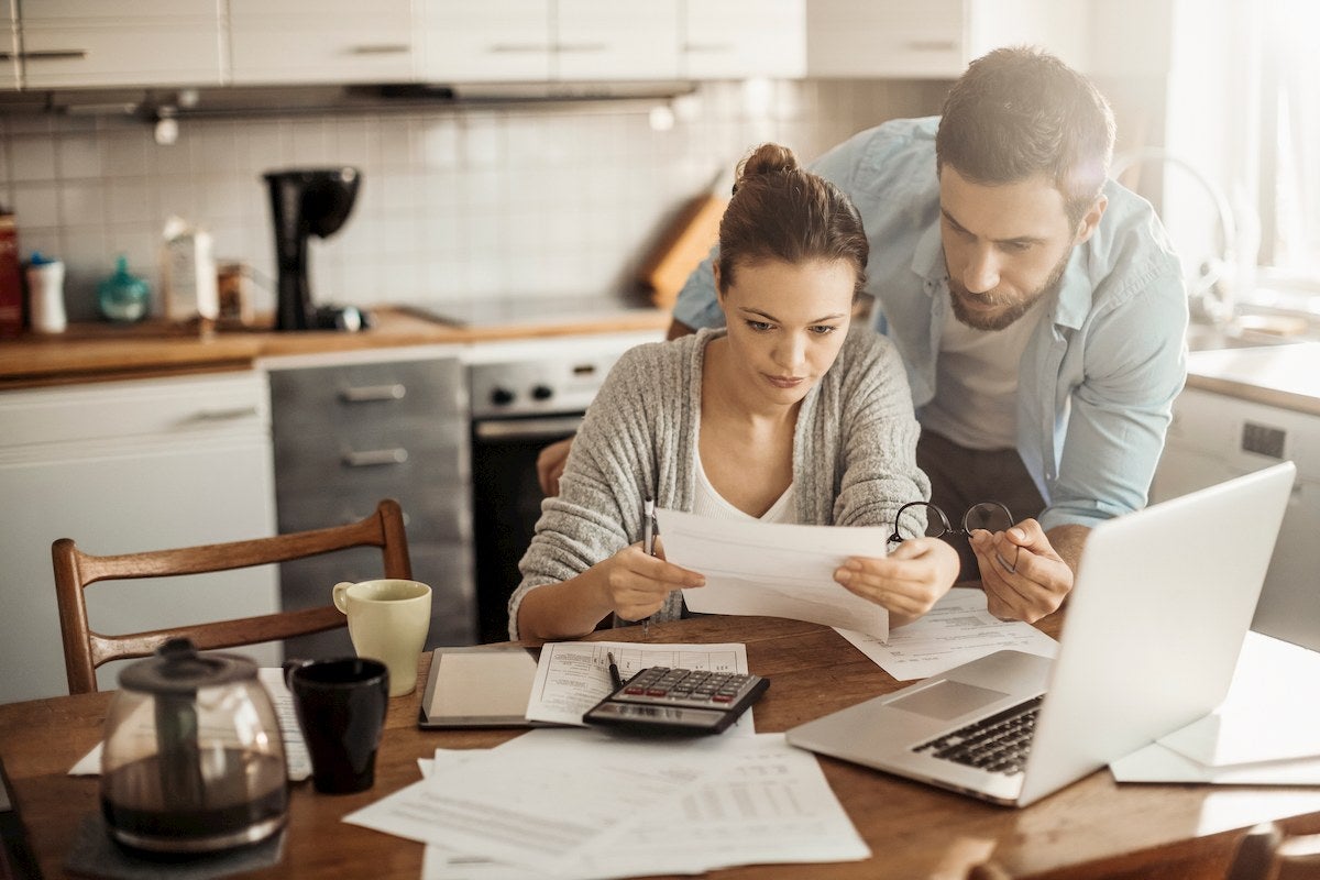 Couple looking concerned with lots of paperwork