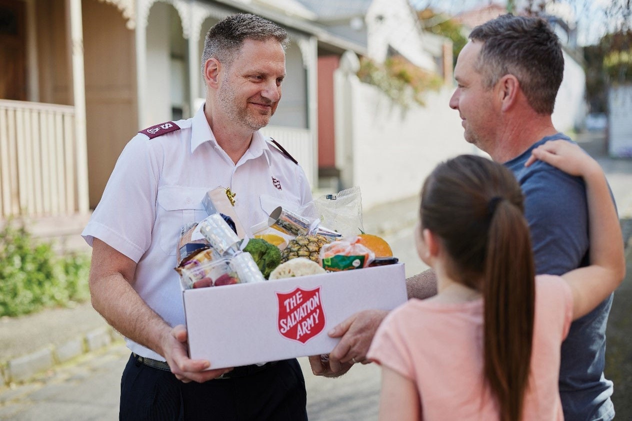 Salvation Army worker with box of produce